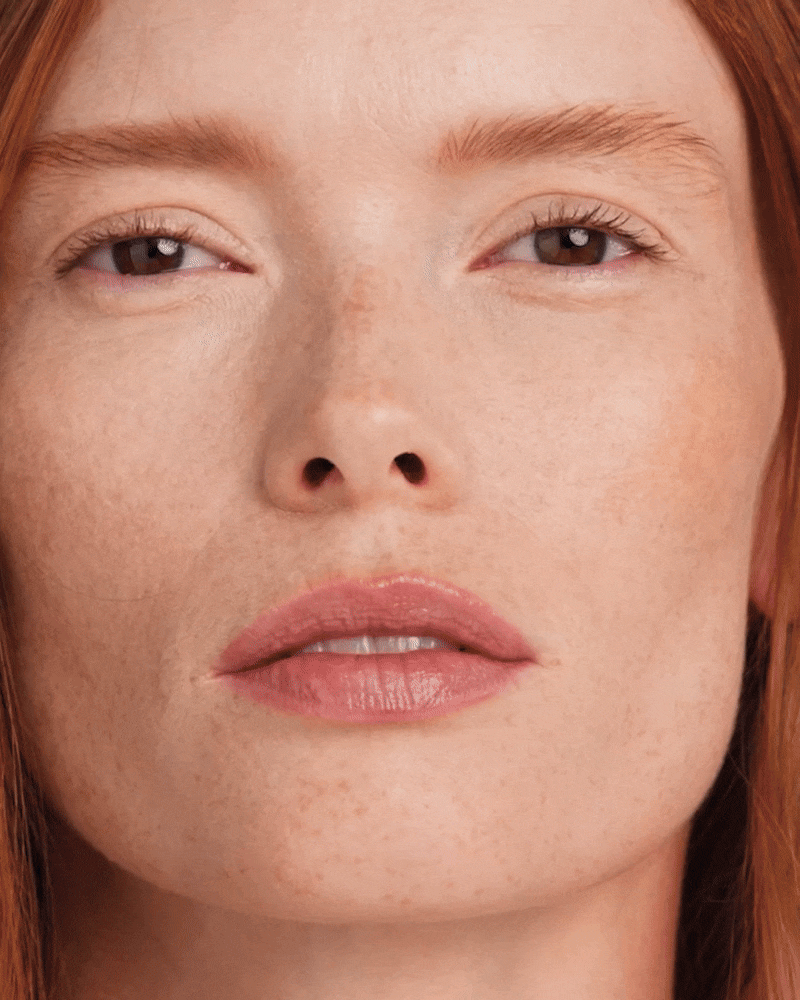 Model applies Vital Skincare Concealer to her undereyes.