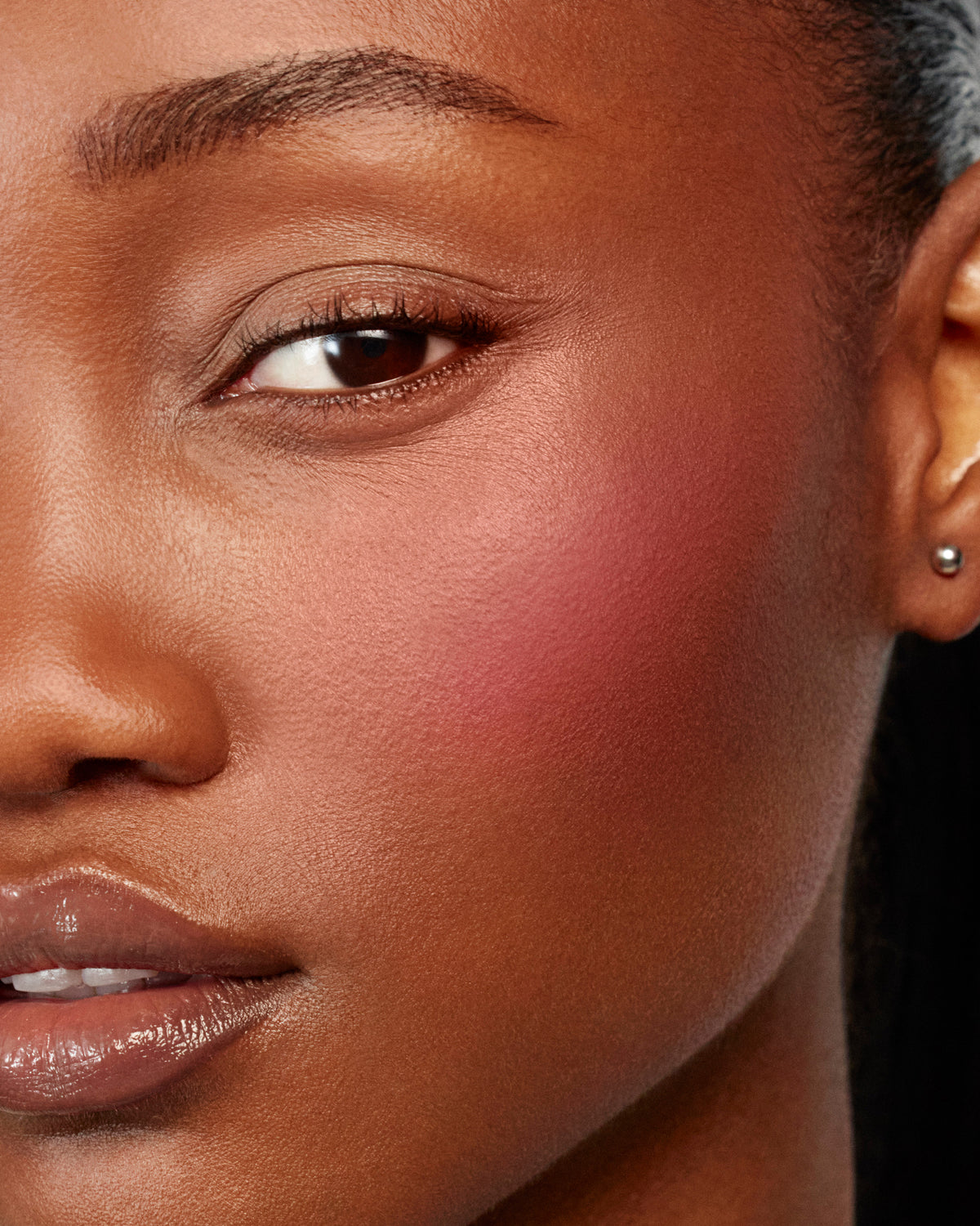 Model wears Baby Cheeks & Face Trace Sculpting Powder Duo in Poppet / Ganache.
