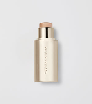 Makeup stick with visible brand name on a light gray background