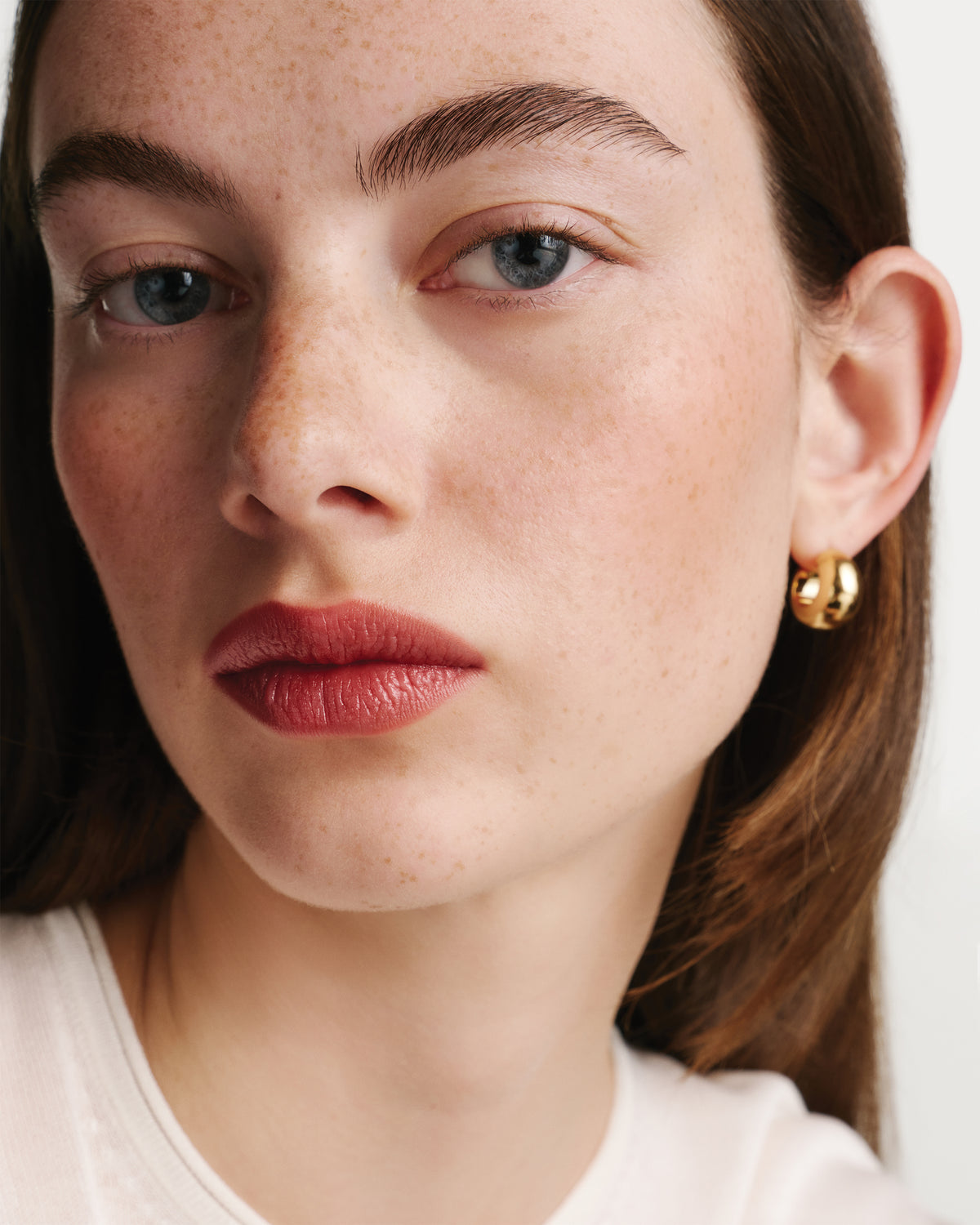 Close-up of a woman wearing red lipstick.