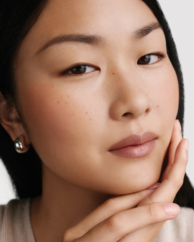 Model wearing HydroBalm in Cafe Creme.