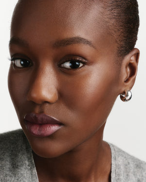 Model wearing HydroBalm in English Rose.
