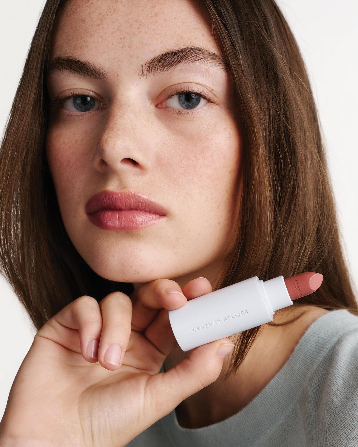 Model wearing HydroBalm in English Rose.
