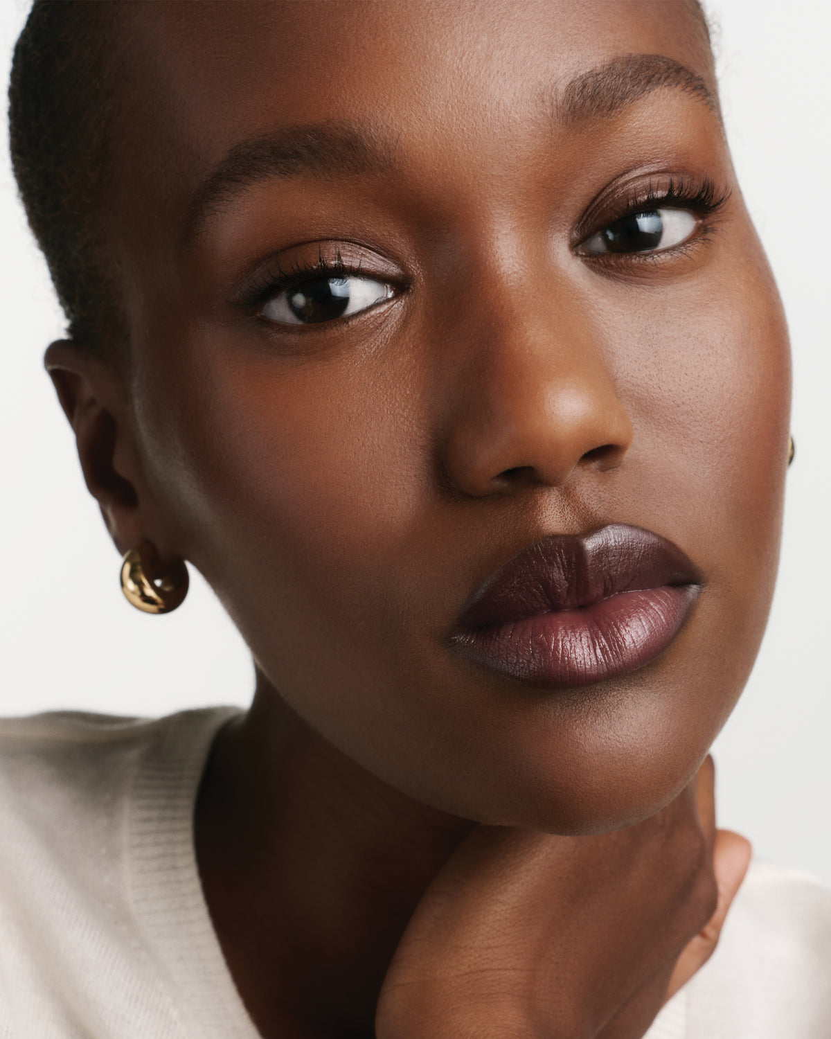 Close-up of a woman wearing berry lipstick.