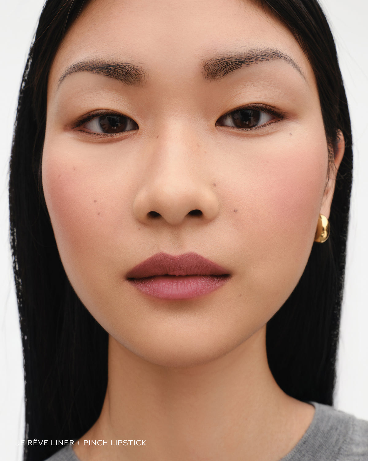 Model wears lip liner in Je Reve and lipstick in Pinch.