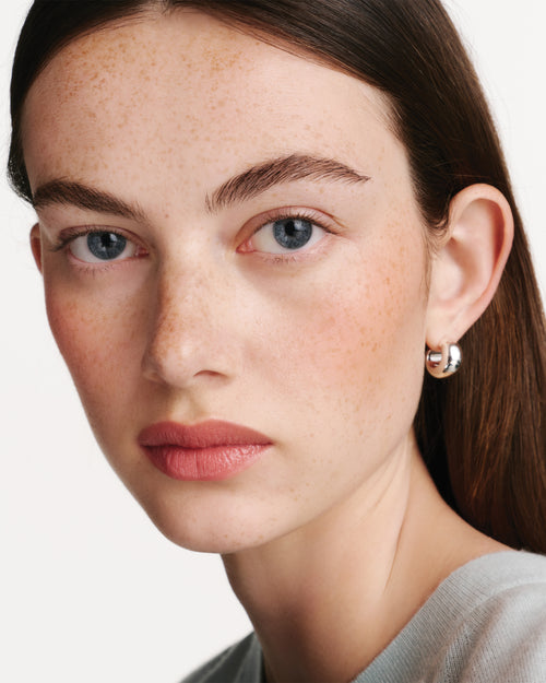 Model wearing HydroBalm in Juice.
