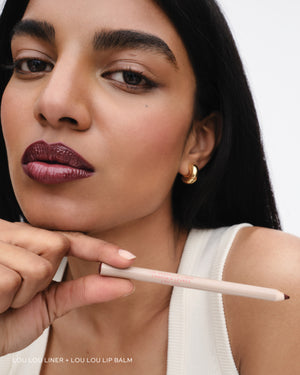 Model wears lip liner in Lou Lou. 