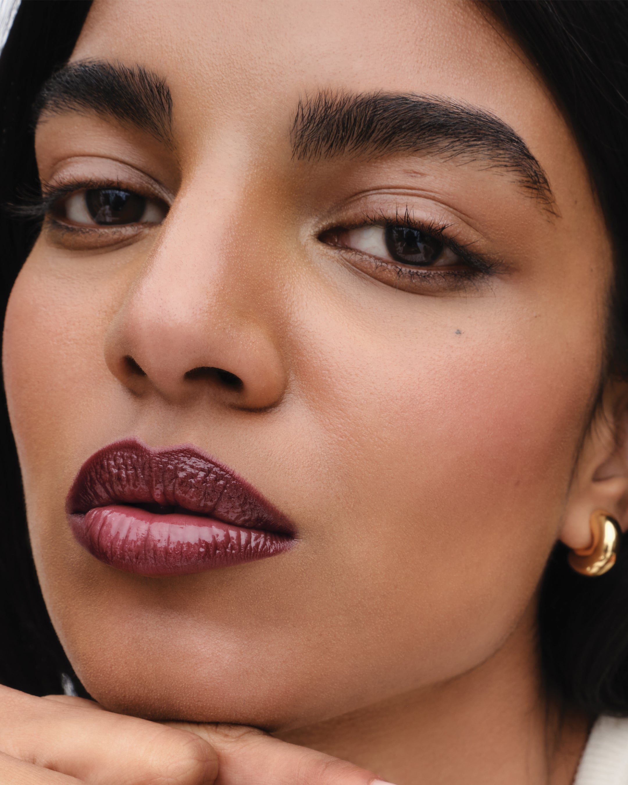 Model wearing Squeaky Clean Lip Balm in Lou Lou.
