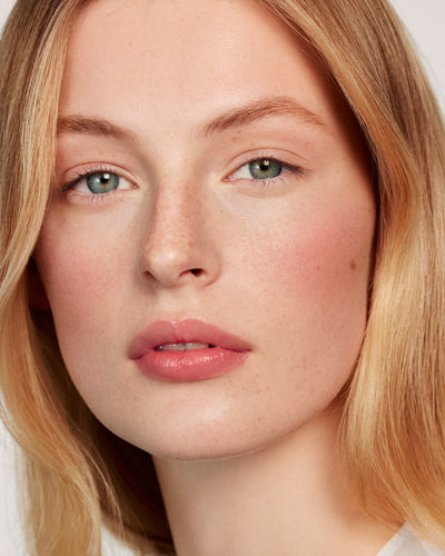 Blonde model wears the Powder Duo in Petal / Biscuit. 