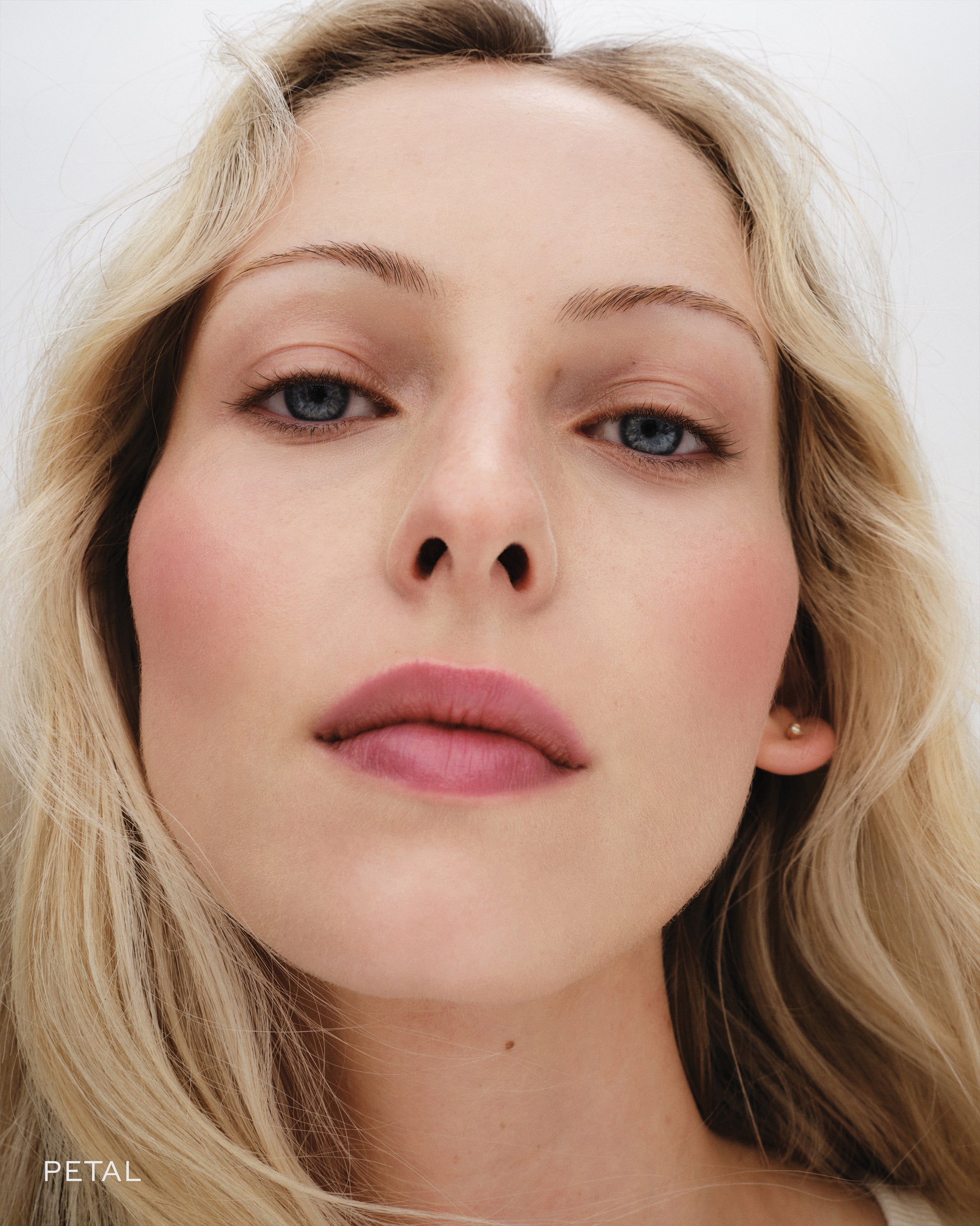 Close up of model wearing Petal Baby Cheeks. 