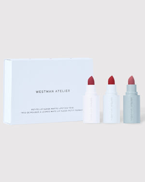 Lipstick set with three lipsticks and a box on a light background.