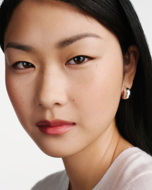 Close-up of a woman's face with a neutral background