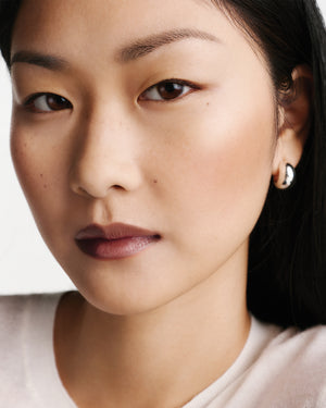 Close up of a model wearing brown lipstick.