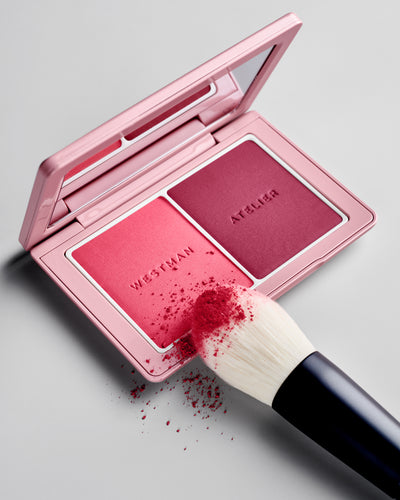 Powder II Brush being tapped into the Baby Cheeks Powder Blush Duo palette in Fizz / Jam. 
