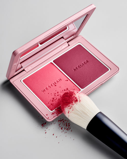 Powder II Brush being tapped into the Baby Cheeks Powder Blush Duo palette in Fizz / Jam. 