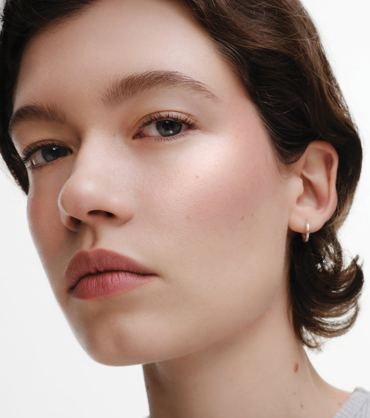 Close-up of a model wearing Lit Up in Garconne on a white background.