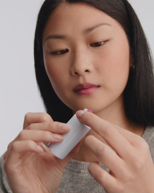 Model applying HydroBalm in English Rose.
