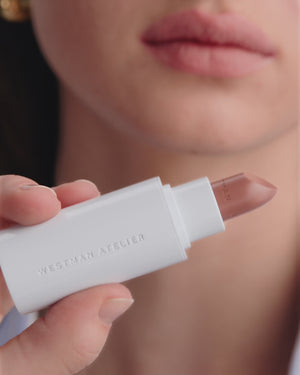 Model applying HydroBalm in Cafe Creme.
